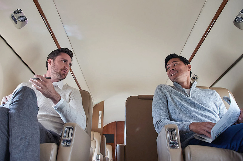 two men talking in a private airplane