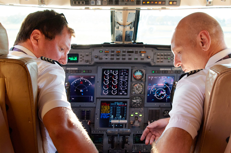 two pilots in a cockpit of private plane